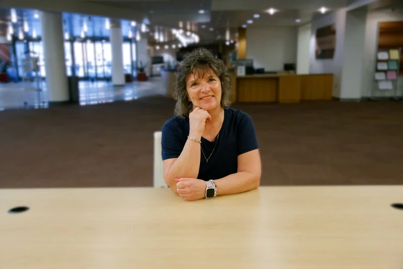 Christine Beltz seated at a table, ready for a live conversation